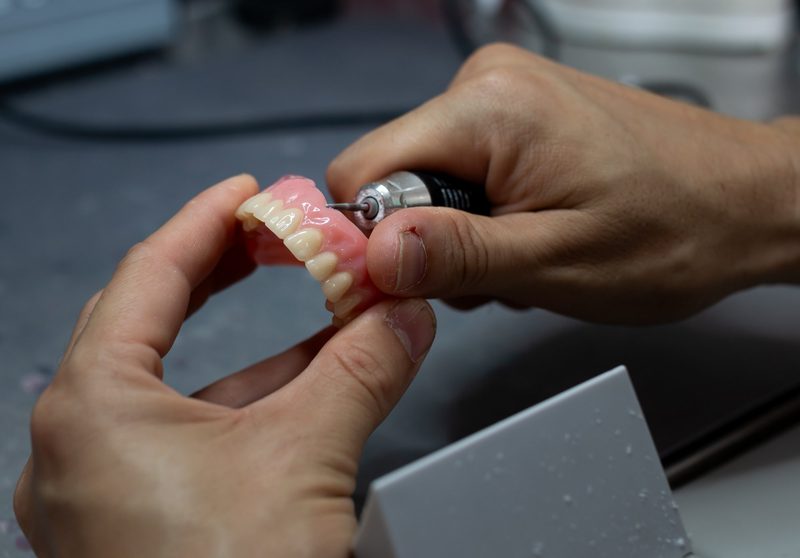 Hand-finishing dentures