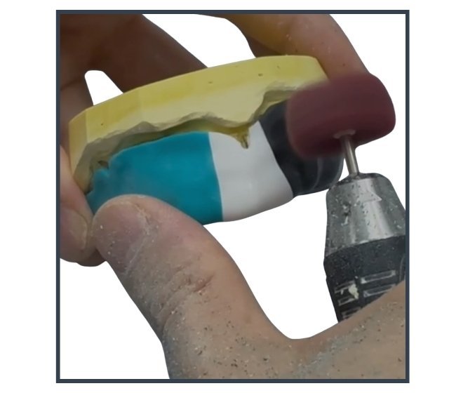 Mouthguard being hand-trimmed